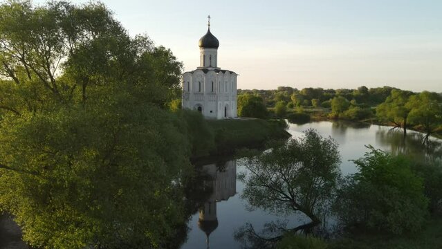 Church of the Intercession on the Nerl in Bogolyubovo, Russia. Famous landmark of the Golden Ring of Russia. Aerial drone view. Beautiful summer landscape at sunrise.