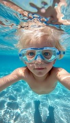 Fototapeta premium Happy caucasian boy child joyfully dives underwater for a fun swimming experience
