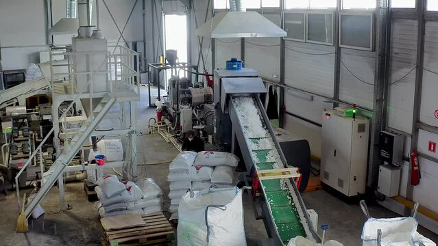 Production process at the industrial plastic compounding plant. Repurposing the plastic material at the compounding plant. Processing the reusable plastic at the compounding plant. Recycling.