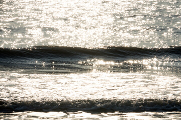 View of the surf on the beach during sunset