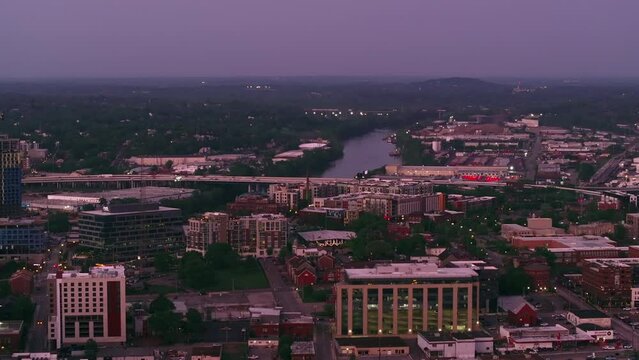 Breathtaking shift from dusk to dawn above Nashville, showcasing its cityscape, architecture, and natural beauty of Cumberland River