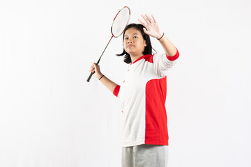 Young Asian woman wearing Indonesian clothing is holding a racket and playing badminton. isolated white background