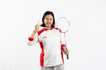 Young Asian woman wearing Indonesian clothing is holding a racket and playing badminton. isolated white background
