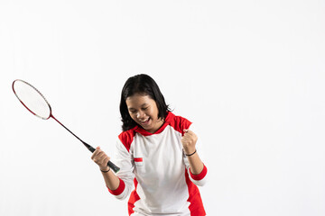 Young Asian woman wearing Indonesian clothing is holding a racket and playing badminton. isolated white background