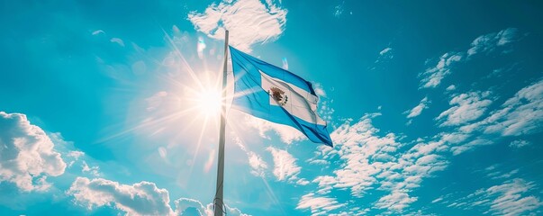 El Salvador flag fluttering against a bright, blue sky