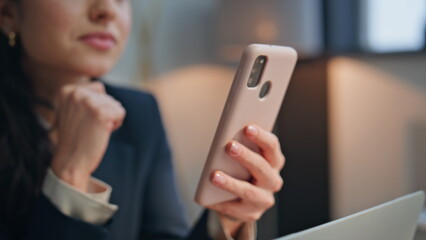 Woman hands holding mobile phone at modern office closeup. Happy lady relaxing