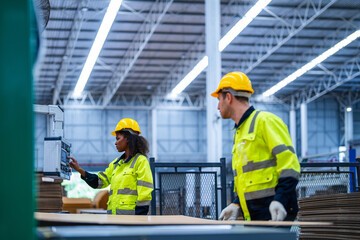 male and female technician engineers checking the process on Heavy machine. mechanical engineering team production. Industry manufacturing. Worker holding tablet and folde. High technology production.