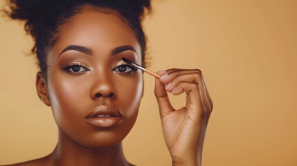 Fototapeta premium A close-up image of a woman applying eyeshadow with a brush. She is looking directly at the camera.