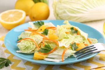 Tasty salad with Chinese cabbage, products and fork on table, closeup