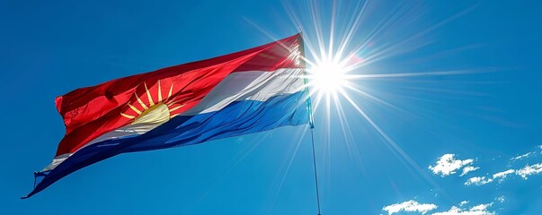 Philippines flag fluttering against a clear, sunny sky