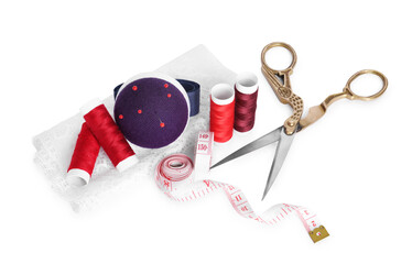 Pincushion, pins and other sewing tools isolated on white