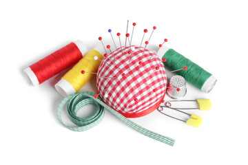 Checkered pincushion with sewing pins, spools of threads, ribbon and thimble isolated on white,...
