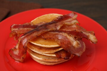 Delicious pancakes with bacon on table, closeup