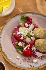 red beetroot hummus with falafel, lemon, sesame, olive oil, pita. Middle eastern, Jewish, arabic cuisine.