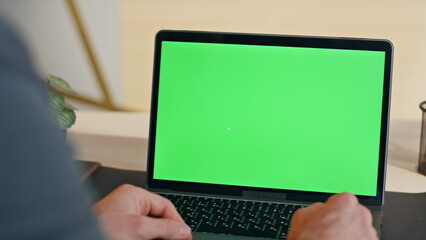 Unrecognizable person using mockup laptop computer working alone at home closeup