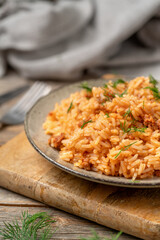 Rice with minced beef in tomato sauce in a plate closeup