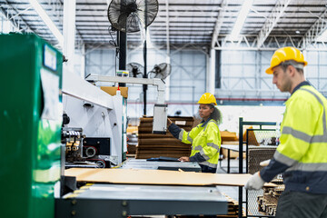 male and female technician engineers checking the process on Heavy machine. mechanical engineering team production. Industry manufacturing. Worker holding tablet and folde. High technology production.