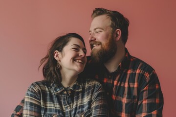 Obraz premium Portrait of a blissful couple in their 30s dressed in a relaxed flannel shirt isolated on solid color backdrop