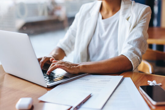 Professional businesswoman working remotely on a laptop in a cafe