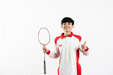 Young Asian man wearing Indonesian clothing is holding a racket and playing badminton. isolated white background