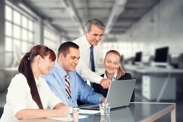 Happy business people discussing project in office