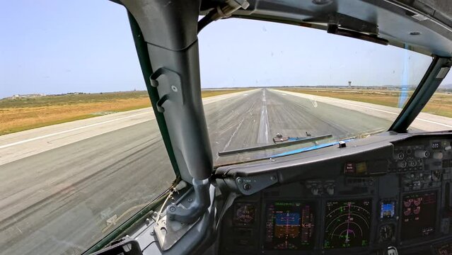 take off or takeoff seen forward view from cockpit of aircraft, airplane, jet plane from holiday destination, travel spot coast line with beach and many instruments and controls on the flightdeck