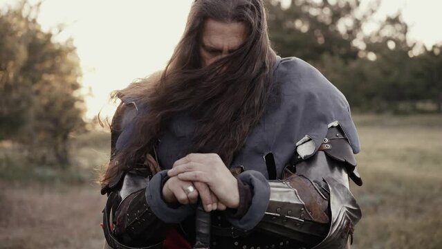 Medieval warrior kneels on the battlefield