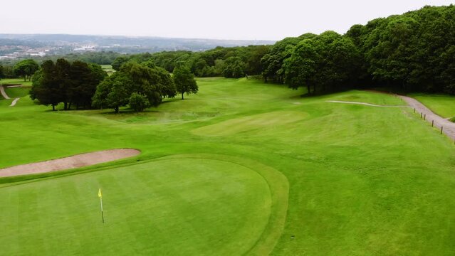 Golf course playing fields in England drone aerial wide shot 