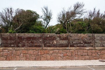 Old stone fence on the street in the town of Algarve, Portugal