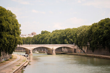 Naklejka premium Embankment Promenade Pedestrian Pathway With Bicycle Lane And Antique Bridge In The Background