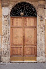 Fototapeta premium Wooden Ancient Antique Door With Metal Arch