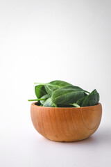 Pile of spinach leaves close-up on a white background