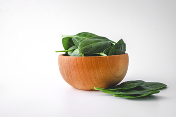 Pile of spinach leaves close-up on a white background