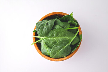 Pile of spinach leaves close-up on a white background