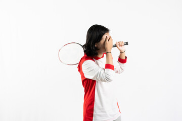 Young Asian woman wearing Indonesian clothing is holding a racket and playing badminton. isolated white background
