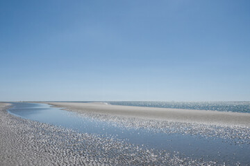 beautiful sandy beach at West Wittering West Sussex England with blue sky in the background