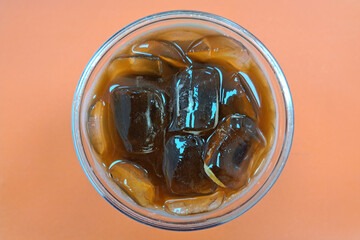 A cup of iced americano coffee on the table.