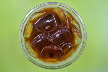 A cup of iced americano coffee on the table.