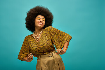 Stylish African American woman with curly hairdoposes against vibrant blue backdrop.