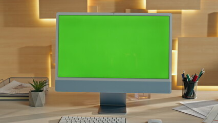 Empty green screen computer display corporate workplace closeup. Chroma key pc