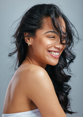 Hair care, happy and woman in studio with wind for beauty, cosmetics and confidence. Smile, pride...