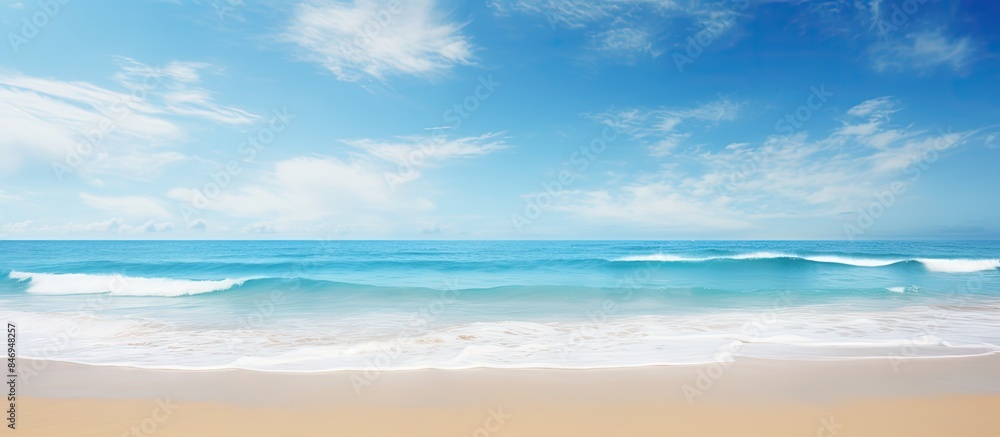 Poster serene beach landscape featuring gentle wave rolling towards the shore under clear blue sky. with co