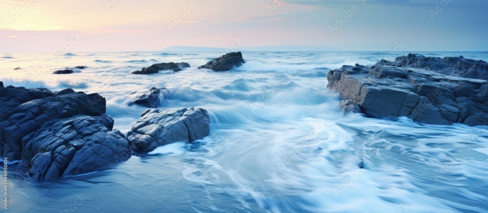 Poster Rocky beach with turbulent waves hitting the shoreline in close-up view. with copy space image. Place for adding text or design