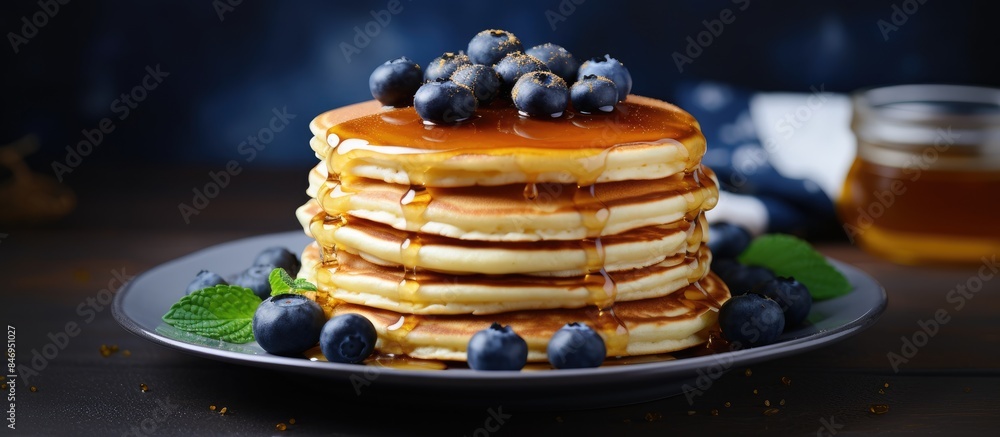 Poster fluffy pancakes topped with sweet syrup and fresh blueberries, a delicious breakfast treat. with cop