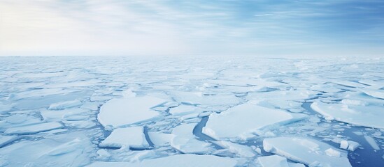 Obraz premium Blue sea ice structure in the Arctic, showing white pancake ice formation floating in the water under a clear blue sky. with copy space image. Place for adding text or design