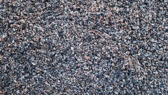 Crushed stone, close-up, top view. Fine granite crushed stone. Construction materials, background. Gravel