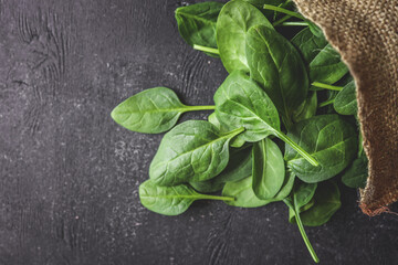 Pile of spinach leaves close-up on a black background