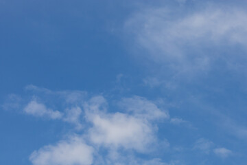 Clear blue sky with white clouds for background.