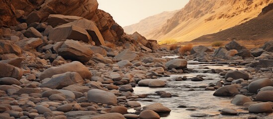 Rocky canyon with a river flowing through it, surrounded by sand and rocks in a dry riverbed. with copy space image. Place for adding text or design