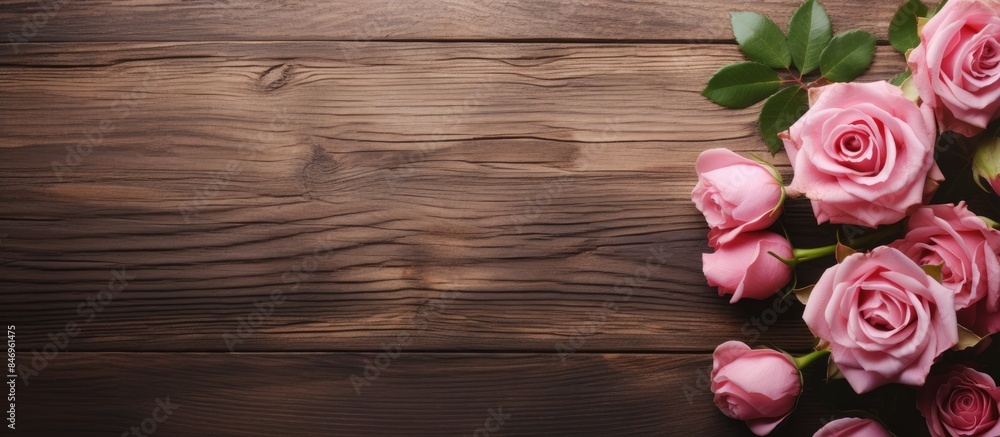 Fototapete Pink roses arranged on a rustic wooden table, creating a beautiful display with ample space for adding text or any message